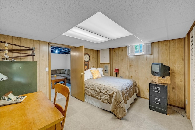 3602 64th St, Urbandale, IA 50322 - bedroom featuring light colored carpet, wood walls, and a paneled ceiling