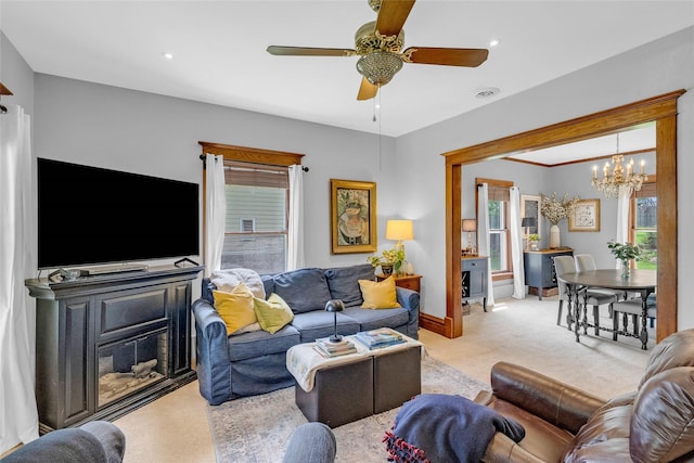 3602 64th St, Urbandale, IA 50322 - living room featuring light colored carpet, a chandelier, plenty of natural light, and a ceiling fan