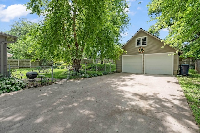 3602 64th St, Urbandale, IA 50322 - view of front facade featuring a detached garage and an outbuilding
