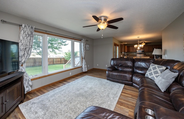 5030 Oakcreek Dr, Norwalk, IA 50211 - living room with a chandelier, a ceiling fan, and wood finished floors