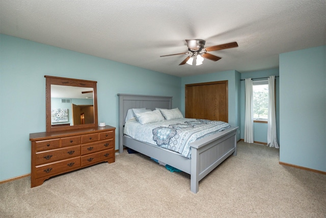 5030 Oakcreek Dr, Norwalk, IA 50211 - bedroom featuring carpet flooring, a ceiling fan, and a closet