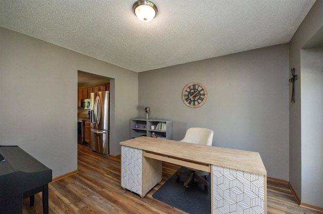 5030 Oakcreek Dr, Norwalk, IA 50211 - office space featuring wood finished floors and a textured ceiling