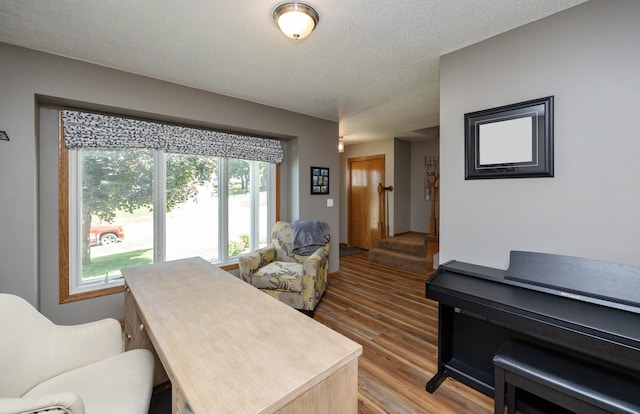 5030 Oakcreek Dr, Norwalk, IA 50211 - living area with light wood-style flooring and a textured ceiling