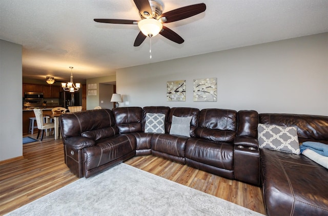 5030 Oakcreek Dr, Norwalk, IA 50211 - living room with a chandelier, wood finished floors, and ceiling fan