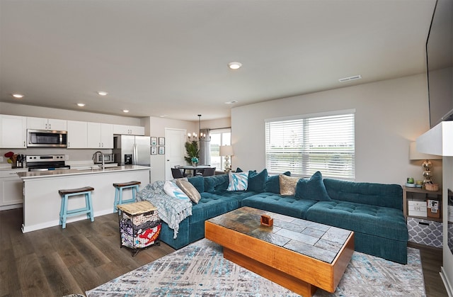 4727 170th Pl, Urbandale, IA 50323 - living room with dark wood-style floors, a chandelier, and recessed lighting