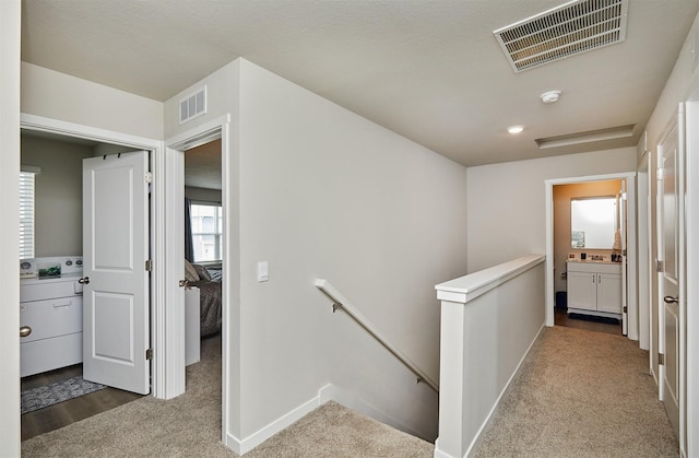 4727 170th Pl, Urbandale, IA 50323 - hall with an upstairs landing and carpet floors