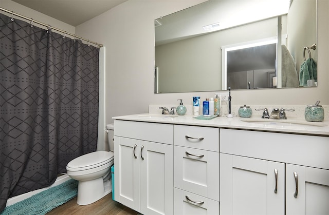 4727 170th Pl, Urbandale, IA 50323 - full bathroom with double vanity, wood finished floors, and a shower with shower curtain