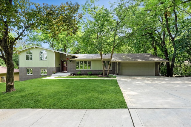 1711 Plaza Cir, Windsor Heights, IA 50324 - tri-level home with brick siding, an attached garage, concrete driveway, and a front yard