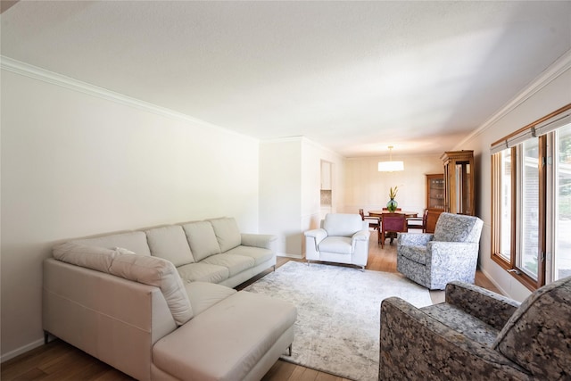 1711 Plaza Cir, Windsor Heights, IA 50324 - living room featuring crown molding, wood finished floors, and a chandelier
