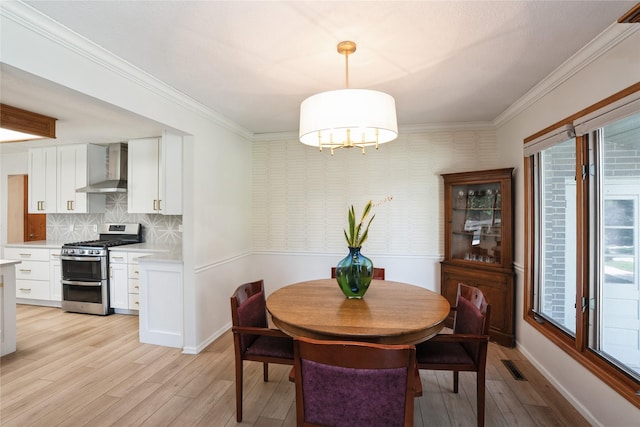 1711 Plaza Cir, Windsor Heights, IA 50324 - dining room featuring light wood-style flooring, ornamental molding, a chandelier, and wallpapered walls