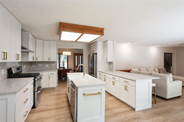 1711 Plaza Cir, Windsor Heights, IA 50324 - kitchen with stainless steel appliances, a peninsula, open floor plan, and light wood-style floors