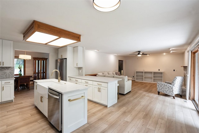 1711 Plaza Cir, Windsor Heights, IA 50324 - kitchen featuring appliances with stainless steel finishes, open floor plan, light countertops, and white cabinets