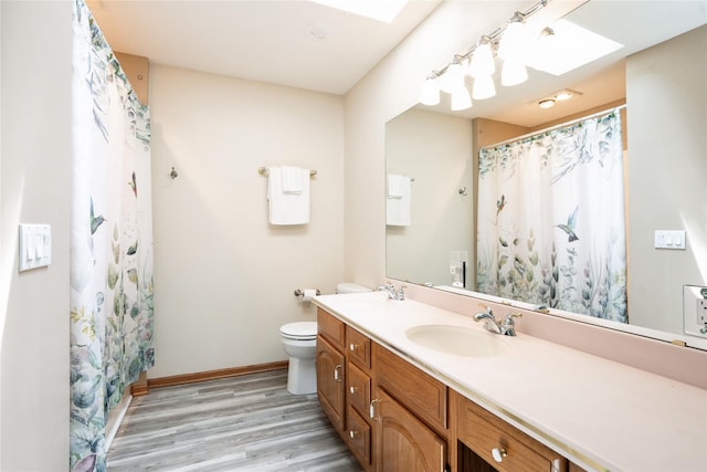 1711 Plaza Cir, Windsor Heights, IA 50324 - bathroom with a skylight, wood finished floors, vanity, and a shower with shower curtain
