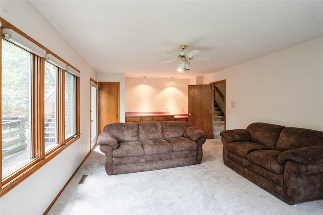 1711 Plaza Cir, Windsor Heights, IA 50324 - carpeted living room with plenty of natural light, stairway, and a ceiling fan