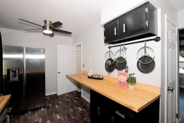 500 Scandia Ave, Des Moines, IA 50315 - kitchen with stainless steel fridge, dark cabinets, and butcher block countertops