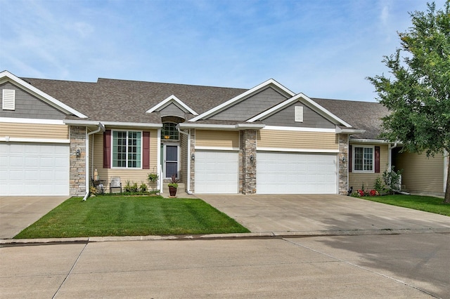 6054 Bradford Ln, Johnston, IA 50131 - view of front facade with stone siding, concrete driveway, a front yard, a garage, and a shingled roof