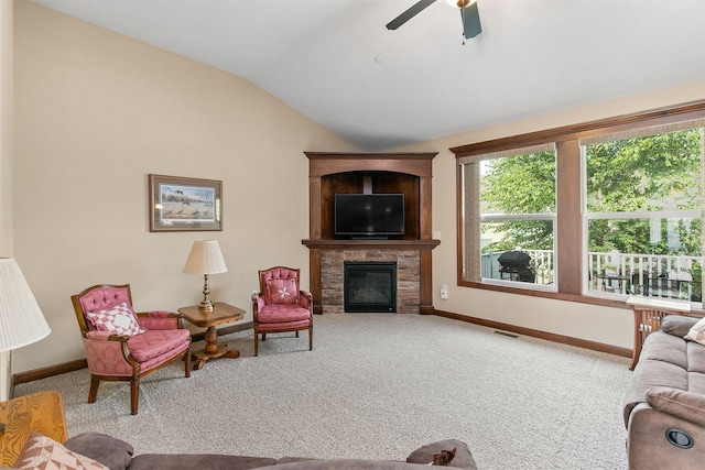 6054 Bradford Ln, Johnston, IA 50131 - living area with carpet flooring, vaulted ceiling, a glass covered fireplace, and ceiling fan