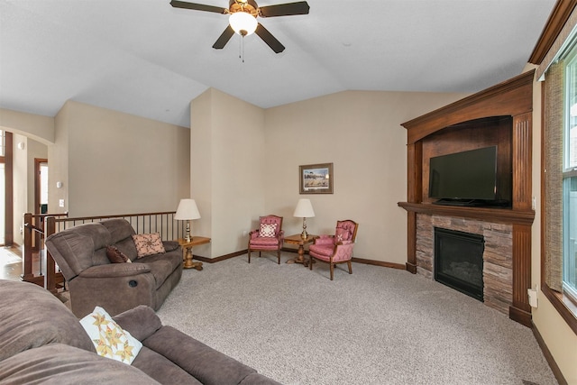 6054 Bradford Ln, Johnston, IA 50131 - carpeted living area featuring ceiling fan, vaulted ceiling, plenty of natural light, a fireplace, and arched walkways