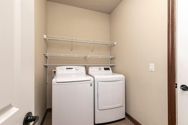 6054 Bradford Ln, Johnston, IA 50131 - laundry area featuring washing machine and dryer and baseboards