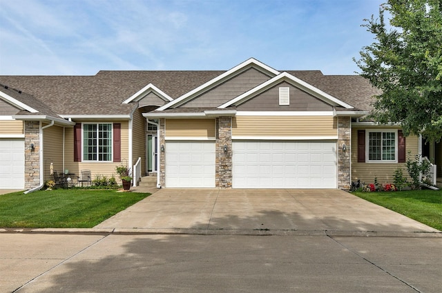 6054 Bradford Ln, Johnston, IA 50131 - view of front facade featuring concrete driveway, a front lawn, a garage, stone siding, and a shingled roof