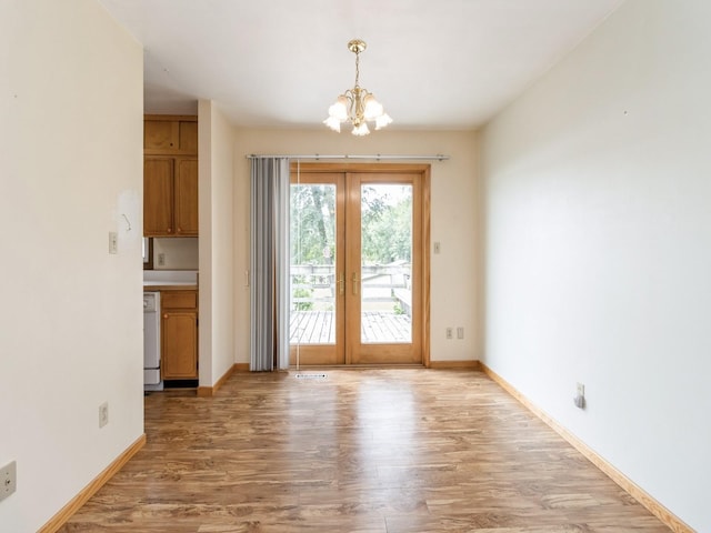 1122 E Ave E, Albia, IA 52531 - doorway featuring a chandelier, french doors, and light wood finished floors