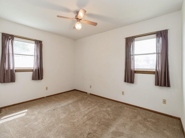 1122 E Ave E, Albia, IA 52531 - spare room featuring carpet and ceiling fan