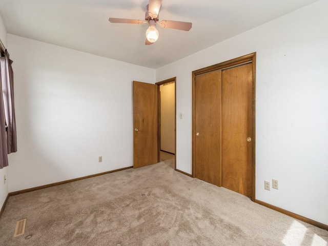 1122 E Ave E, Albia, IA 52531 - unfurnished bedroom featuring carpet, a closet, and ceiling fan