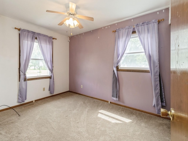 1122 E Ave E, Albia, IA 52531 - unfurnished room with healthy amount of natural light, ceiling fan, and carpet