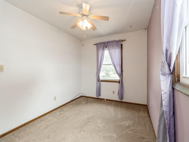 1122 E Ave E, Albia, IA 52531 - carpeted empty room featuring ceiling fan and baseboards