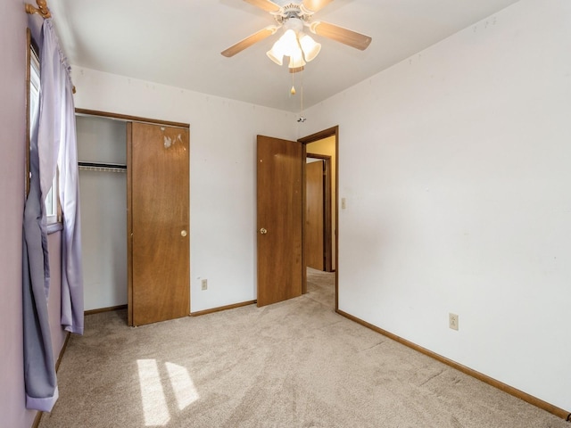 1122 E Ave E, Albia, IA 52531 - unfurnished bedroom featuring carpet floors, a closet, and ceiling fan