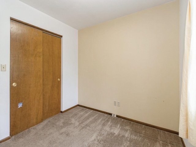 1122 E Ave E, Albia, IA 52531 - unfurnished bedroom featuring carpet floors and a closet