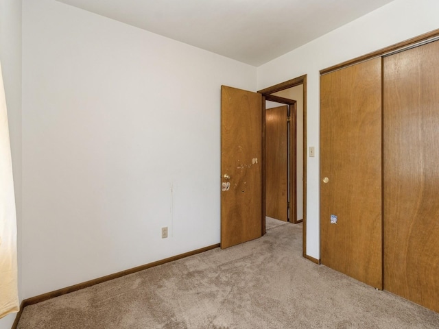 1122 E Ave E, Albia, IA 52531 - unfurnished bedroom with carpet floors and a closet