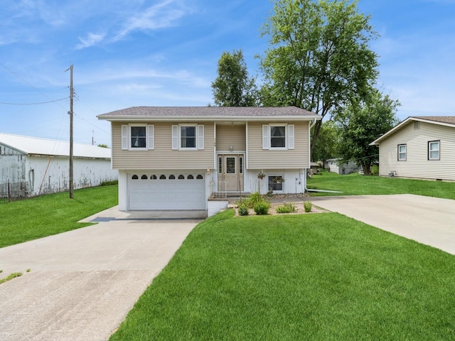 1122 E Ave E, Albia, IA 52531 - bi-level home featuring driveway, a garage, and a front yard