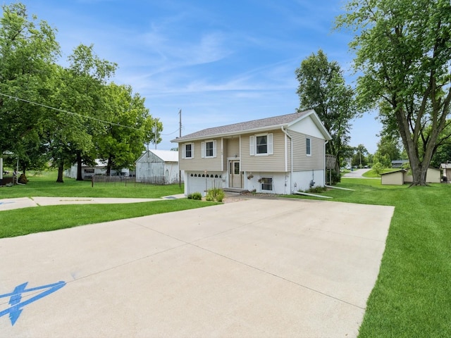 1122 E Ave E, Albia, IA 52531 - split foyer home with an attached garage, concrete driveway, and a front lawn