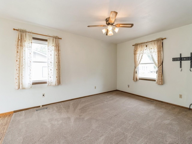 1122 E Ave E, Albia, IA 52531 - carpeted empty room featuring plenty of natural light and a ceiling fan