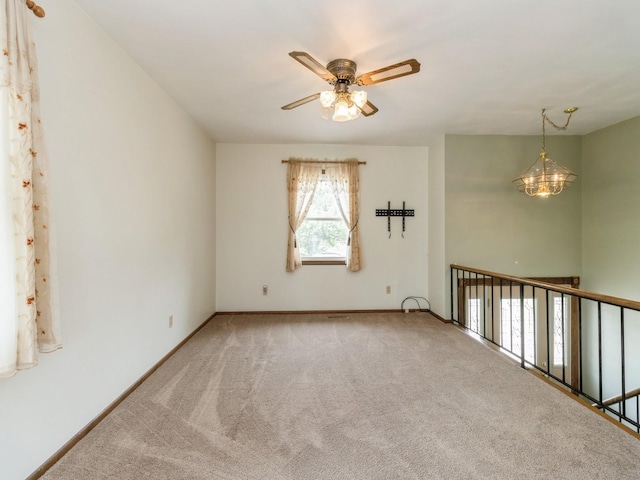 1122 E Ave E, Albia, IA 52531 - unfurnished room featuring ceiling fan and carpet floors