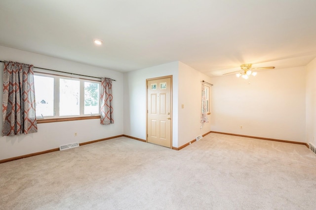 4326 E Washburn Rd, Waterloo, IA 50702 - unfurnished room with light carpet, a ceiling fan, and recessed lighting