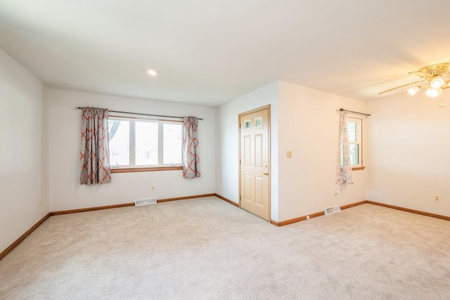 4326 E Washburn Rd, Waterloo, IA 50702 - spare room featuring light colored carpet and a ceiling fan