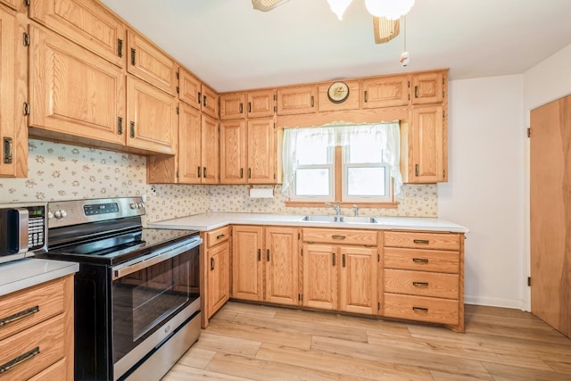 4326 E Washburn Rd, Waterloo, IA 50702 - kitchen with stainless steel appliances, light wood finished floors, and light countertops