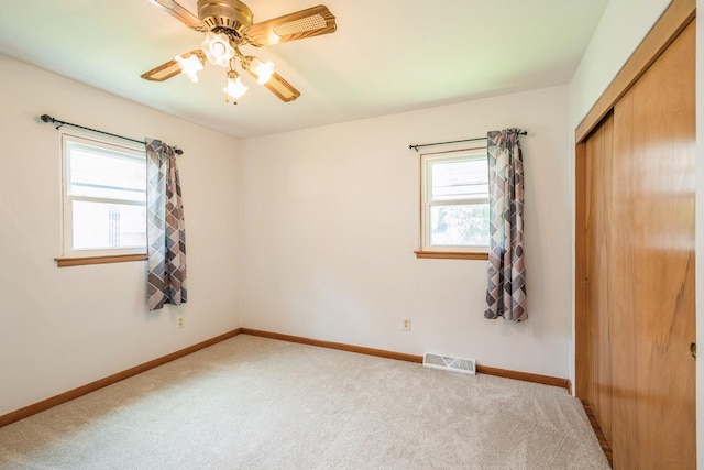 4326 E Washburn Rd, Waterloo, IA 50702 - unfurnished bedroom featuring a closet, carpet, and a ceiling fan
