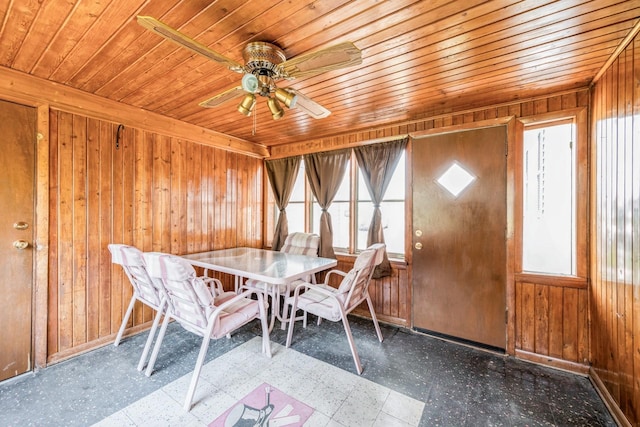 4326 E Washburn Rd, Waterloo, IA 50702 - dining area with tile patterned floors, wood walls, wooden ceiling, and a ceiling fan