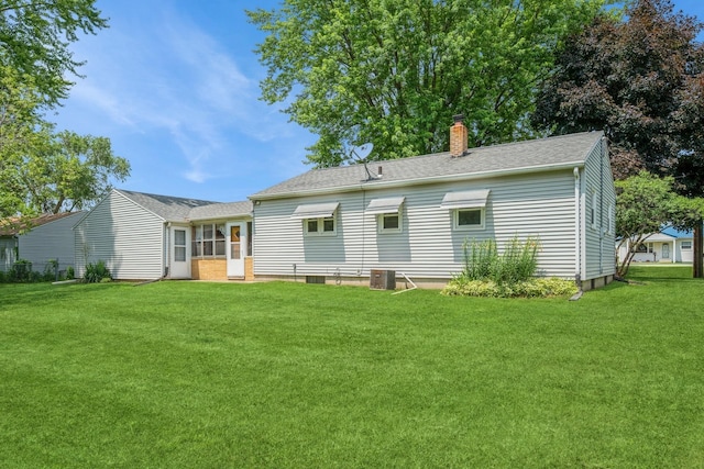 4326 E Washburn Rd, Waterloo, IA 50702 - back of house featuring a chimney, a lawn, and roof with shingles
