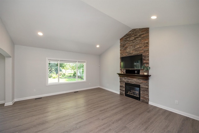 296 S 82nd St, West Des Moines, IA 50266 - unfurnished living room with wood finished floors, arched walkways, vaulted ceiling, a fireplace, and recessed lighting
