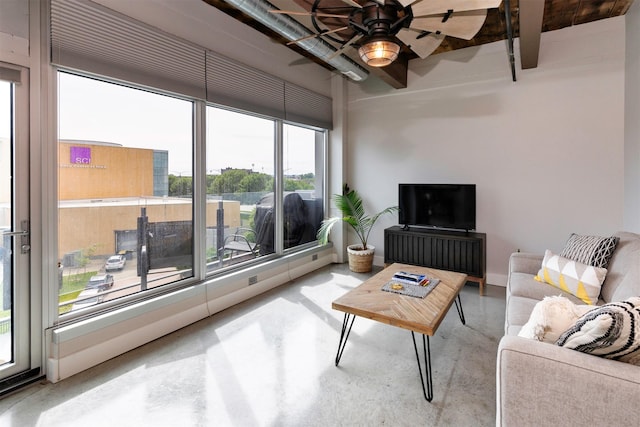 120 SW 5th St Unit 306, Des Moines, IA 50309 - living area featuring concrete floors, ceiling fan, and beamed ceiling