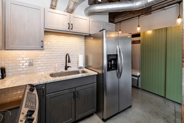 120 SW 5th St Unit 306, Des Moines, IA 50309 - kitchen featuring stainless steel refrigerator with ice dispenser, finished concrete floors, backsplash, and light stone counters
