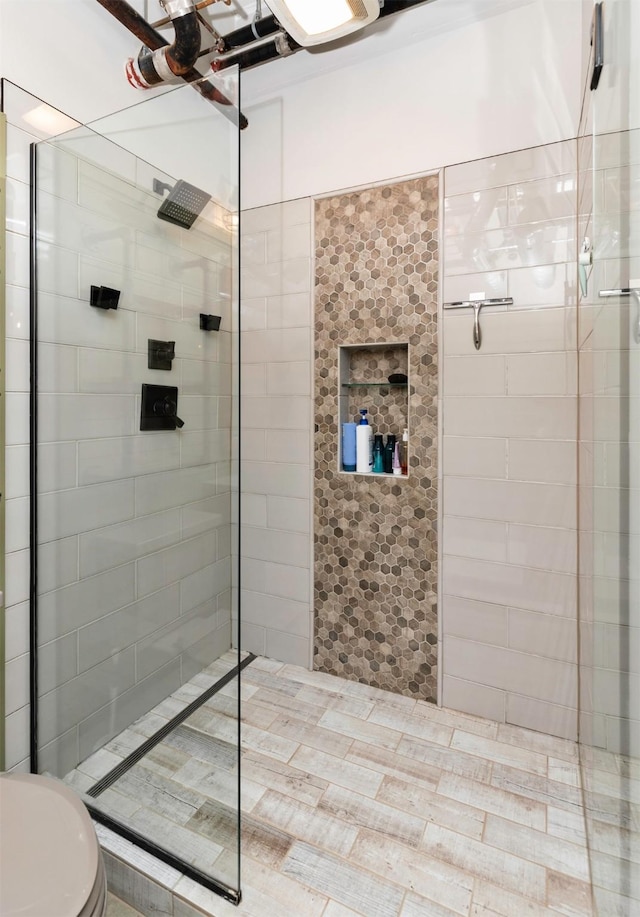 120 SW 5th St Unit 306, Des Moines, IA 50309 - full bathroom with a walk in shower and toilet