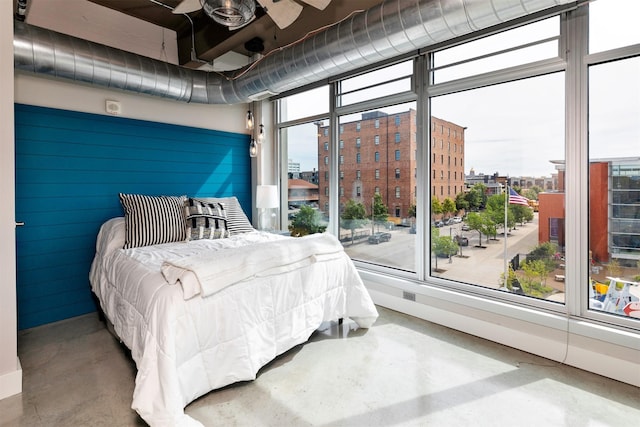 120 SW 5th St Unit 306, Des Moines, IA 50309 - bedroom featuring finished concrete floors and a city view