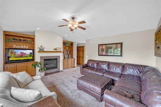 904 Pleasant St SE, Bondurant, IA 50035 - living room with lofted ceiling, ceiling fan, carpet, built in shelves, and a fireplace with flush hearth