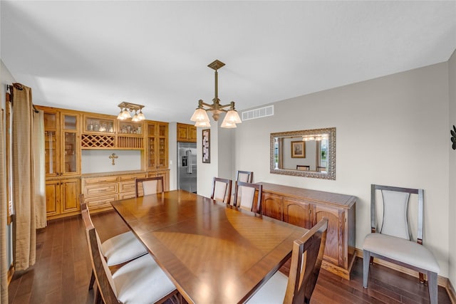 904 Pleasant St SE, Bondurant, IA 50035 - dining room featuring dark wood-style flooring and a chandelier