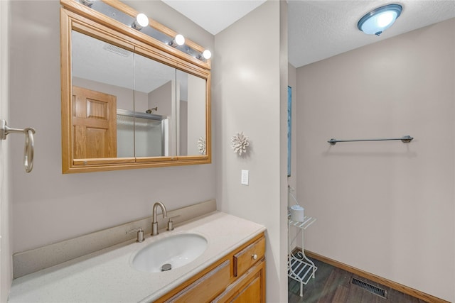 904 Pleasant St SE, Bondurant, IA 50035 - full bathroom featuring vanity, wood finished floors, and an enclosed shower